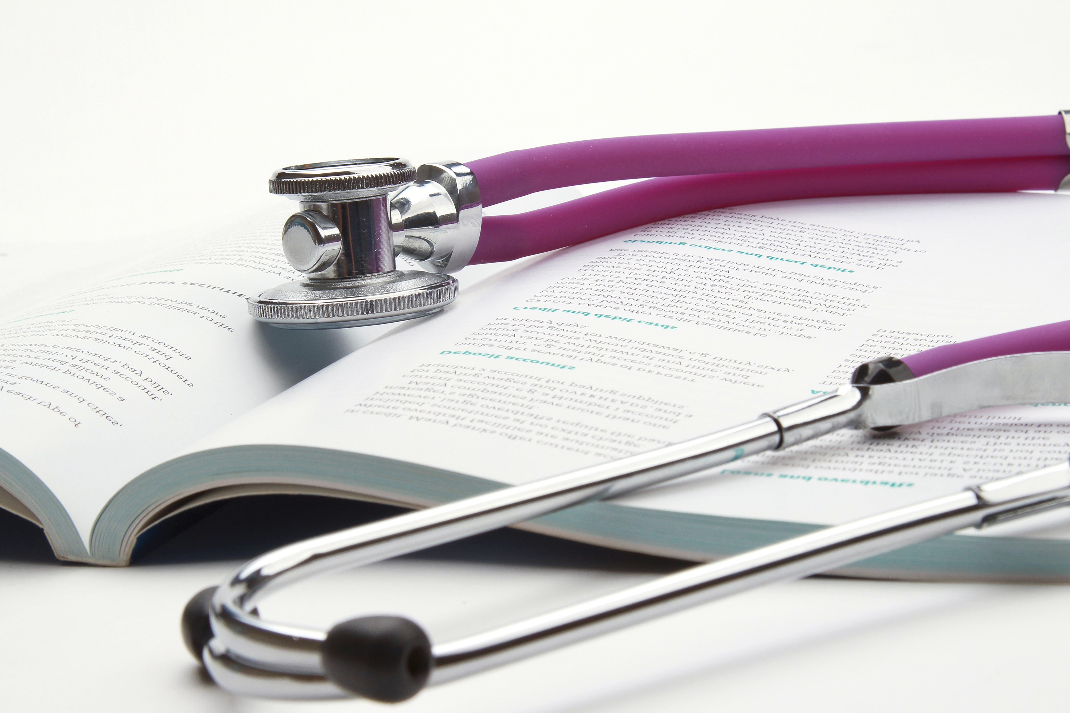 book and stethoscope isolated on white background