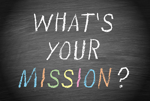 Das Bild zeigt eine Tafel mit der Aufschrift What's your Mission?