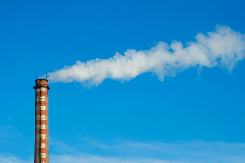 Industrial smoking chimney on blue sky. Thermal Power Plant
