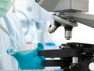 Scientist with dropper working  at the laboratory