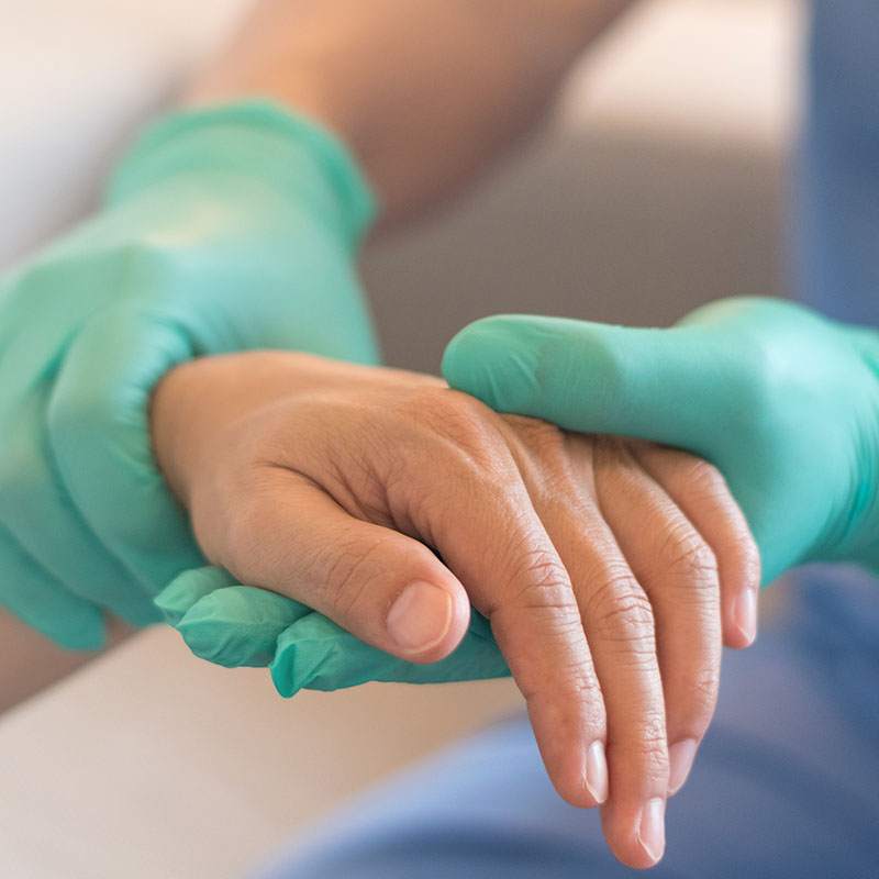 Surgeon, physician performs surgical operations, anesthetist or anesthesiologist holding patient's hand for checking state of and or support in ER room, Medical healthcare concept 
