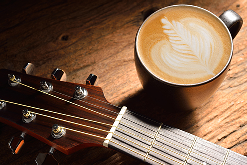 amenic181130800002.jpg - a cup of cafe latte and guitar on wooden table