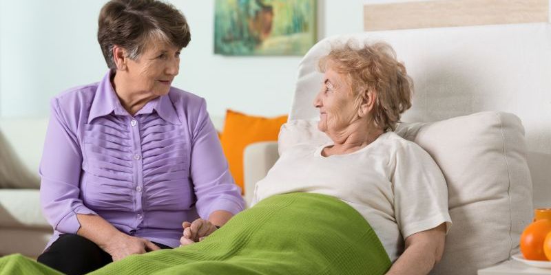 Woman visiting her sick elderly friend