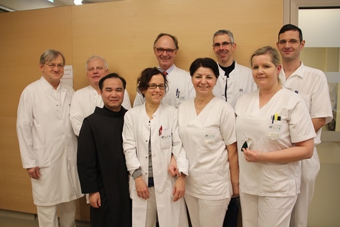 Gruppenfoto mit Ärzten und Pflegersonen der Onkologie mit Pater Prior Antonius Nguyen OH.