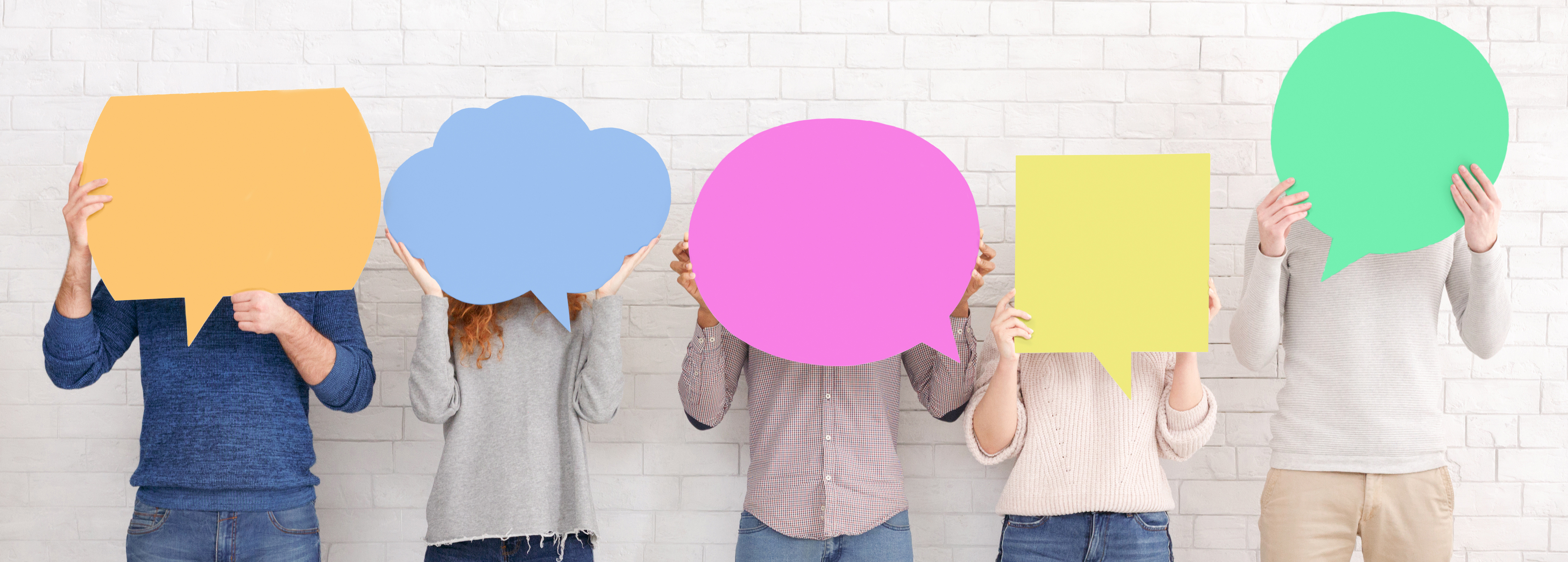 Friends holding speech bubbles with copy space over white wall, crop