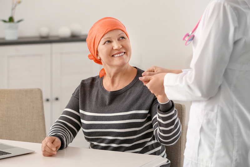 Mature woman with cancer visiting doctor in hospital�