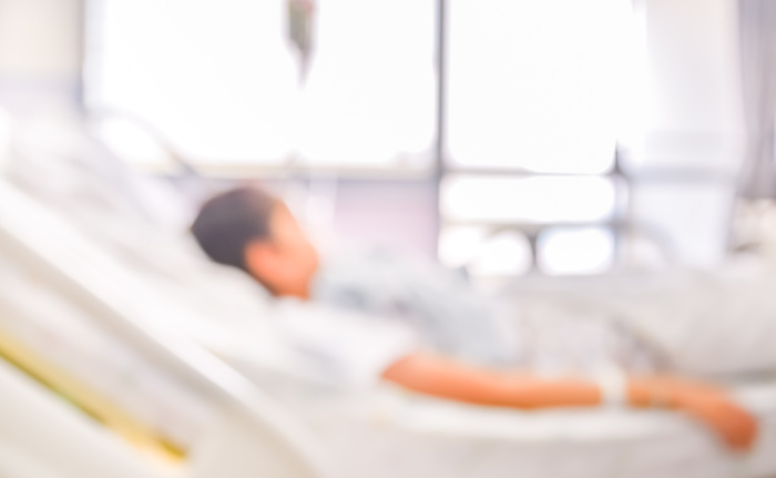 blurred image of Patient with drip in hospital for background usage.