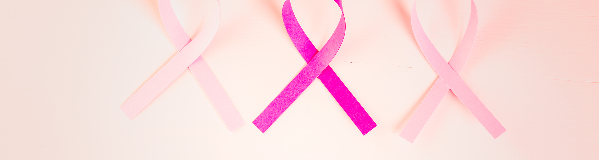 Womens health symbol in pink ribbon on wooden board.