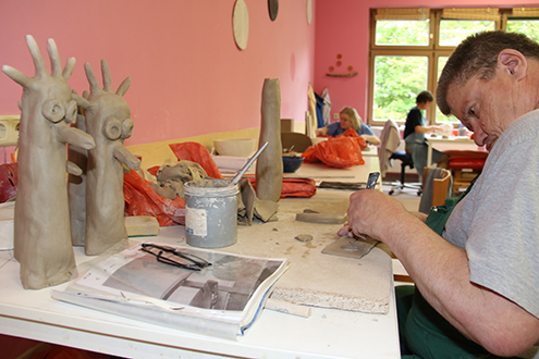 Das Bild zeigt einen Klienten in der Keramikwerkstatt