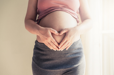 Happy pregnant woman with baby in pregnant belly. Maternity prenatal care and woman pregnancy.