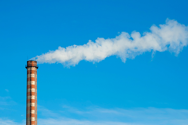 Industrial smoking chimney on blue sky. Thermal Power Plant