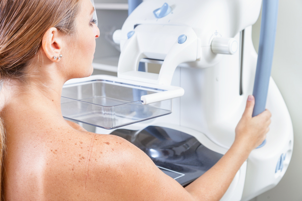 Woman undergoing medical mammography scan.