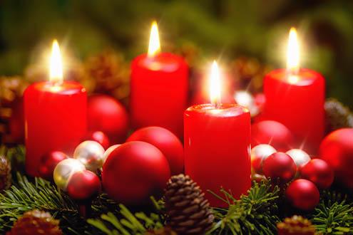Studio shot of a nice advent wreath with baubles and four burning red candles