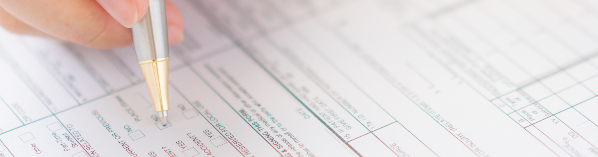 Hand with pen over application form .