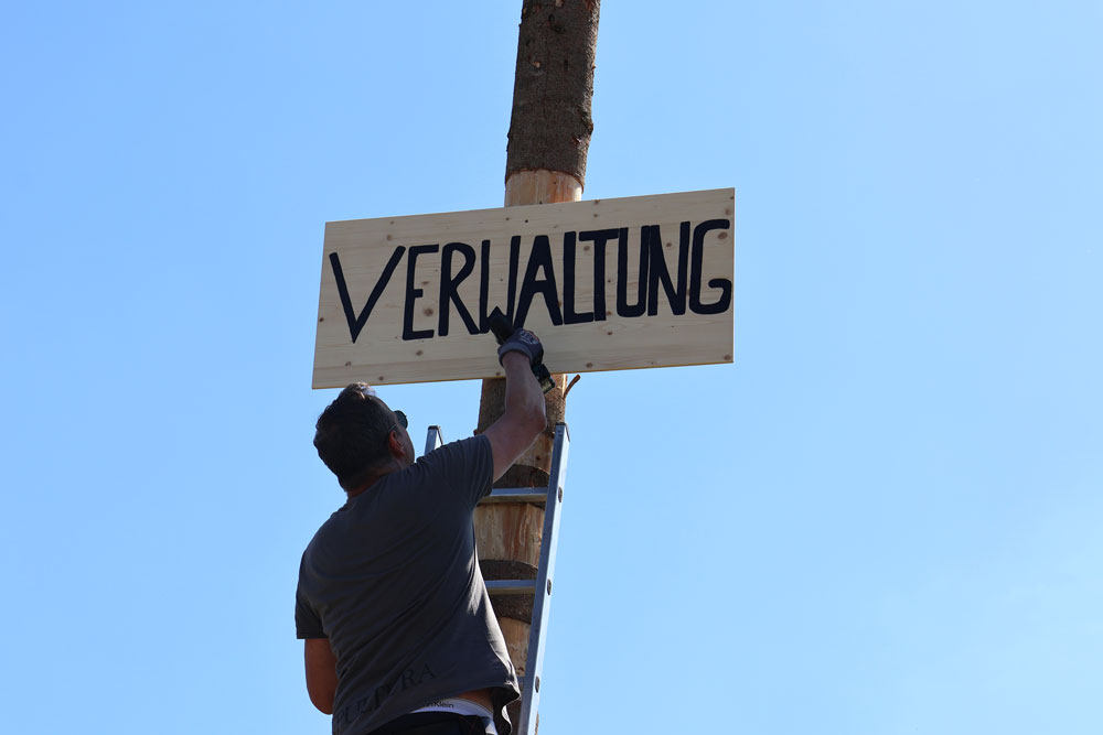 DSA Hermann Neuretter (Sozialberatung/Verwaltung) montierte das Schild am Maibaum.